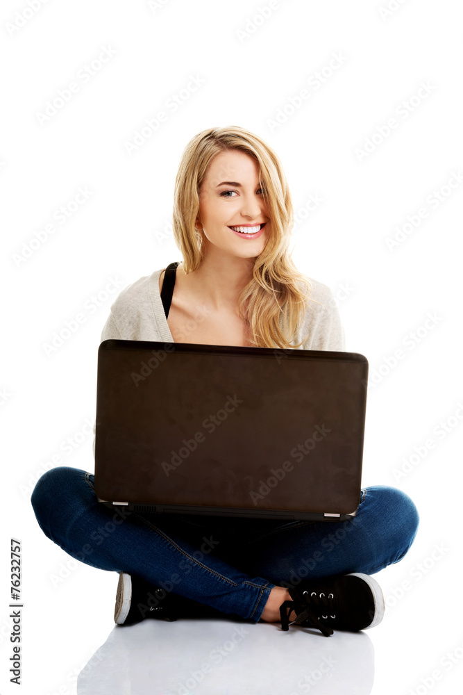 Smiling woman using a laptop Smiling woman using a laptop