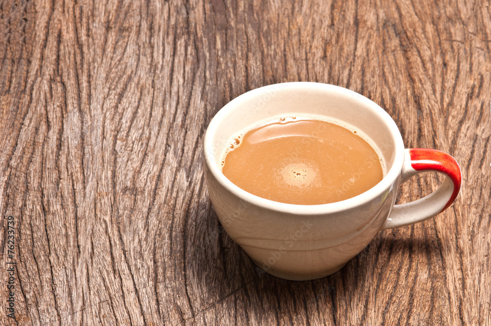 A cup of coffee on wood background A cup of coffee on wood background