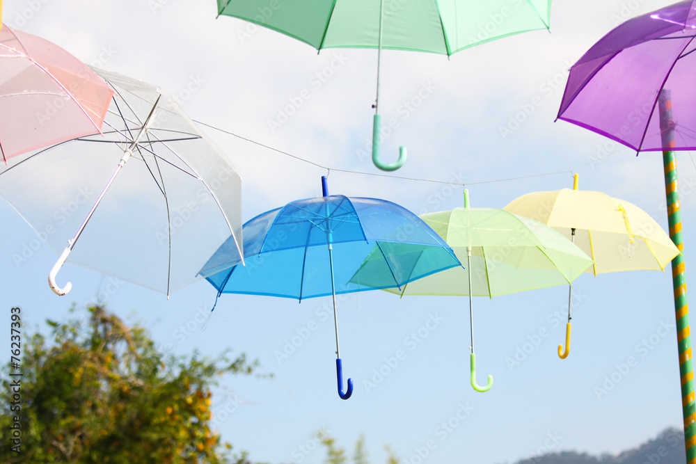 Obraz premium Colorful of umbrellas hang on the sky with blue sky background