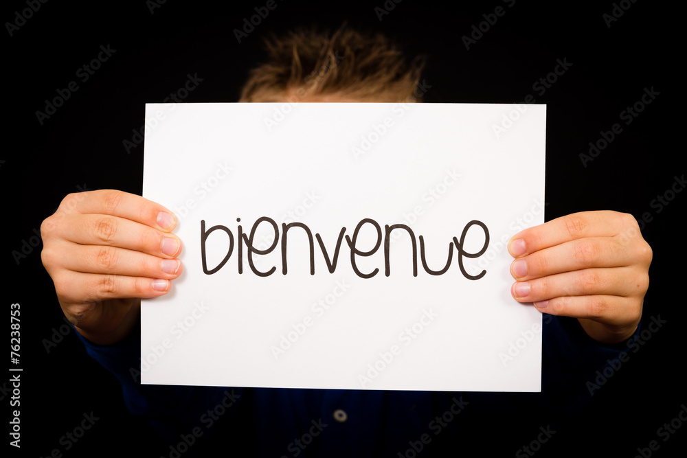 Child holding sign with French word Bienvenue - Welcome Child holding sign with French word Bienvenue - Welcome