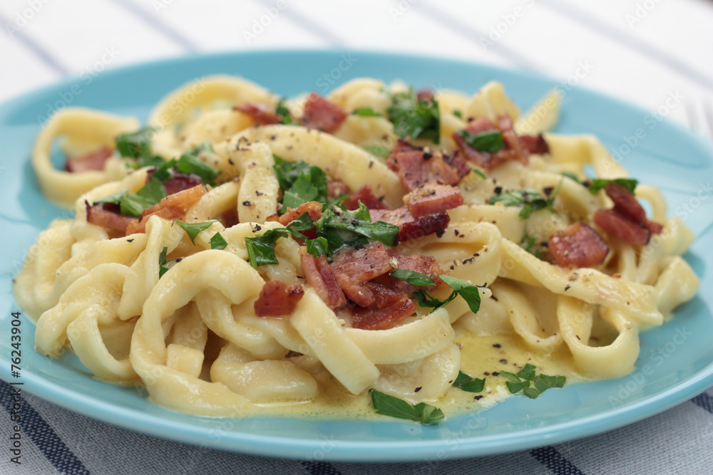 Fresh and beautiful fettuccine carbonara on blue plate. Fresh and beautiful fettuccine carbonara on blue plate.