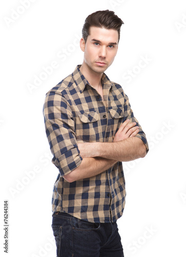 Confident young man posing with arms crossed