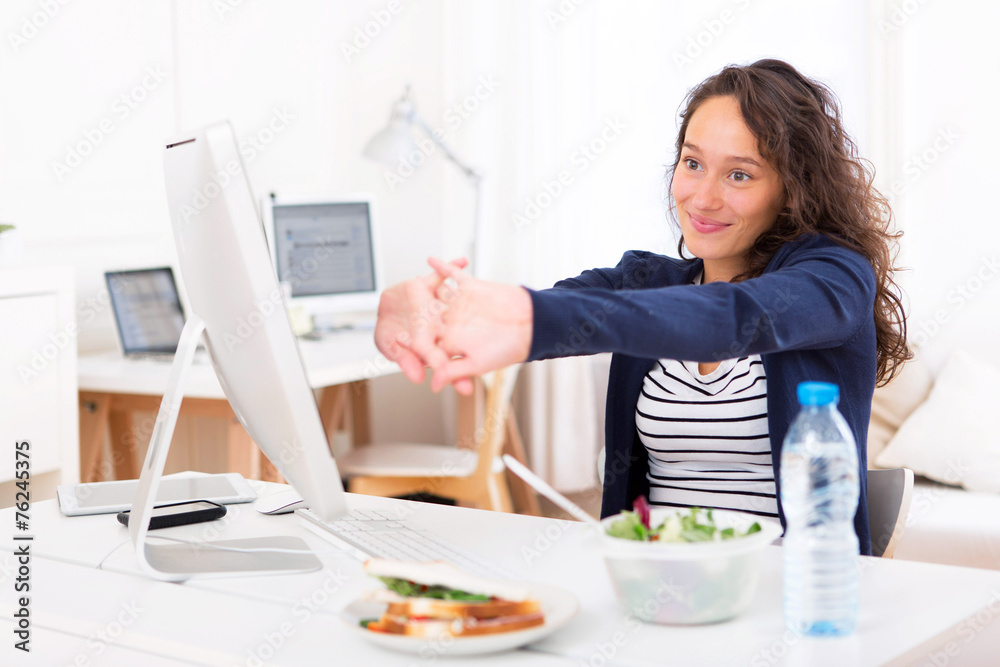 Young attractive woman stretching during a break Young attractive woman stretching during a break