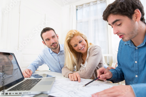 young serious couple meeting a real estate agent