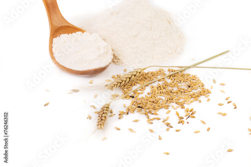 Flour wheat ear and wood spoon.