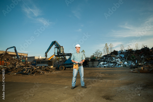 worker in scrap metal recycling center