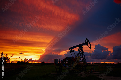 Oil derricks on a background of beautiful sunset