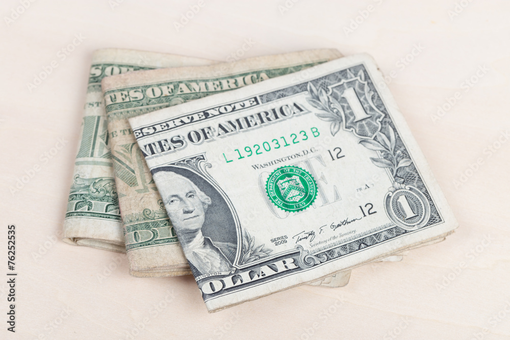 used US banknotes on wood table close up used US banknotes on wood table close up