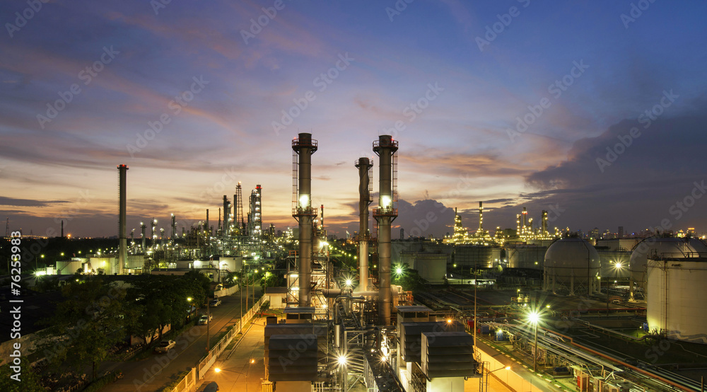 Oil refinery plant at sunset, The night view of petroleum and petrochemical factory with distillation column, drum and pipeline. Gas, diesel and chemical business industry is important for economy.