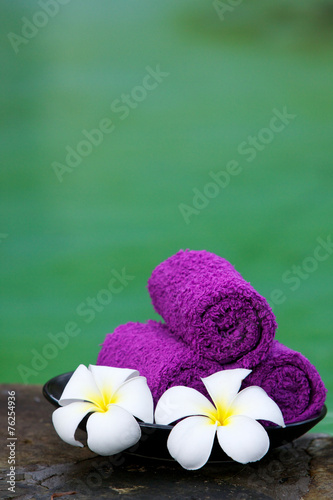 Towels with white frangipani flowers.