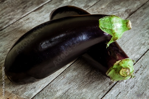 Two raw organic eggplant on old wooden background
