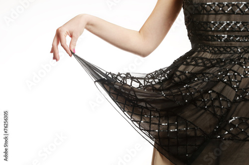 Girl holding the hemline of her glamour sequin dress photo