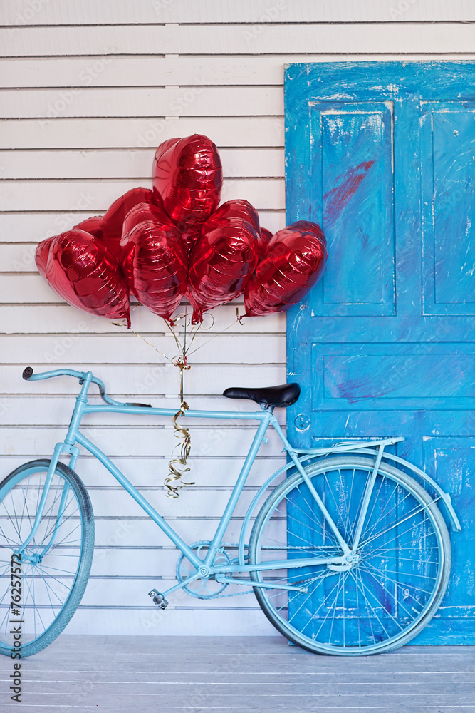 Blue bicycle with heart-shaped balloons. Valentine's day.