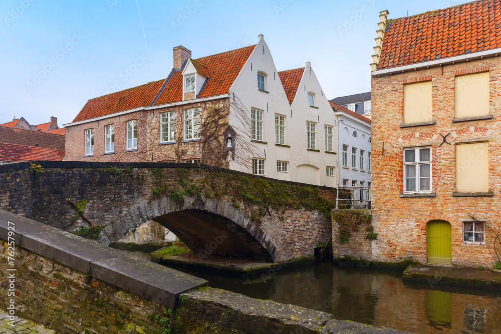 Green canal and bridge in Bruges, Belgium