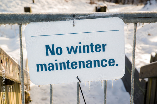 Frozen No Winter Maintenance Sign on a Gate