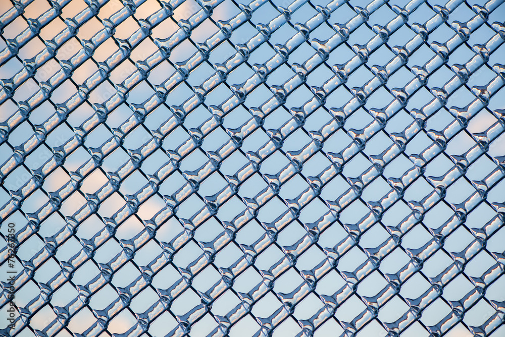Fototapeta premium Refracted Clouds and Blue Sky Through Ice on Fence