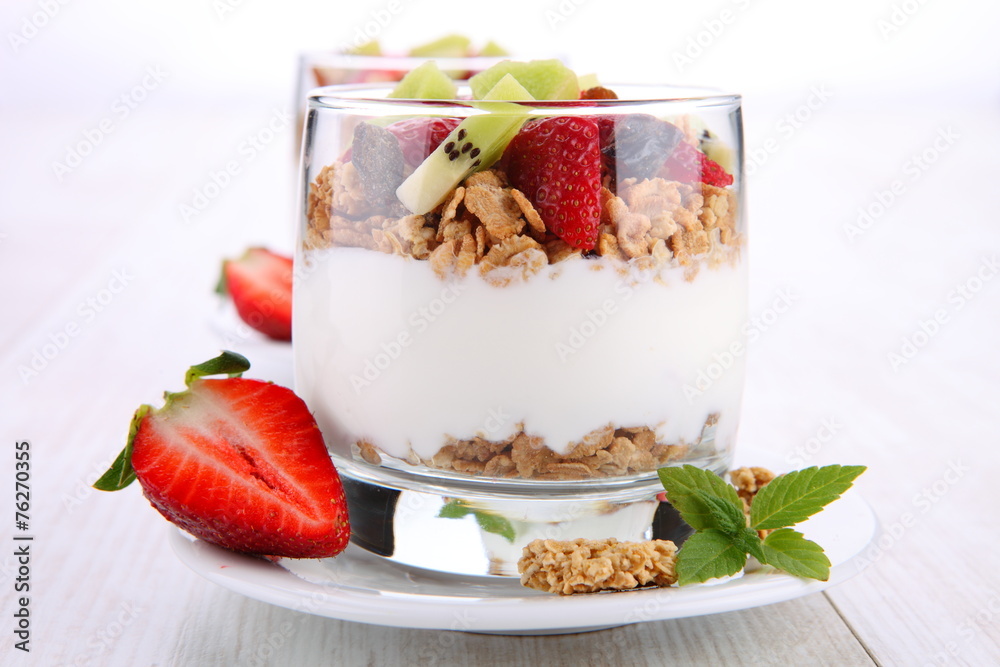 yogurt dessert with muesli and berries in small glass yogurt dessert with muesli and berries in small glass