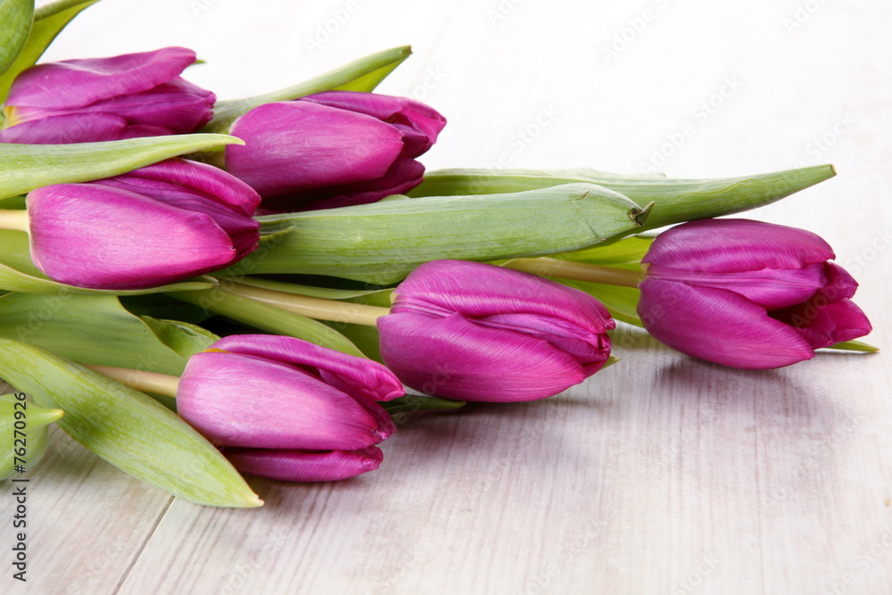 Tulips on wooden table composition