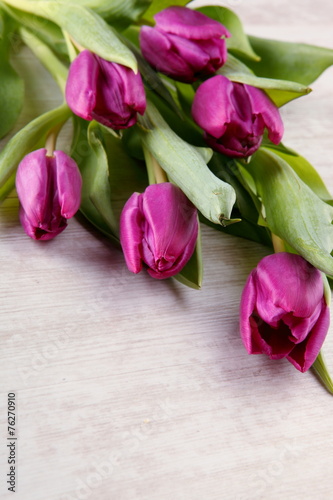 Tulips on wooden table composition