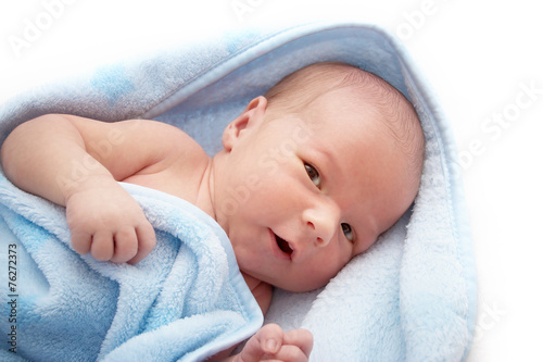 One week old baby in a blanket on white background