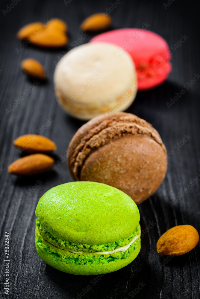 Colorful French macaroons on a dark rustic wooden background, Colorful French macaroons on a dark rustic wooden background,