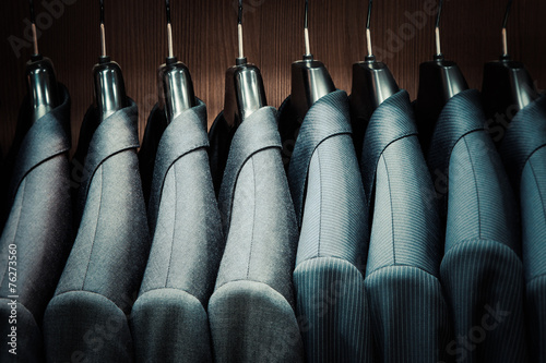Valokuvatapetti Row of men suit jackets on hangers
