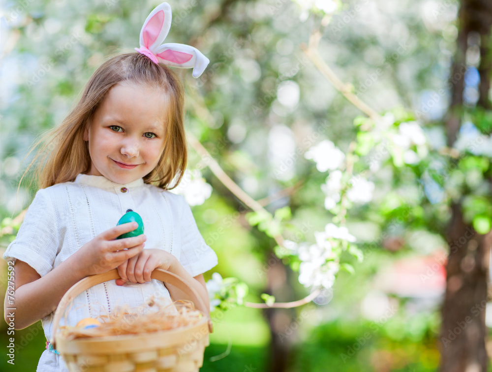 Little girl playing with Easter eggs