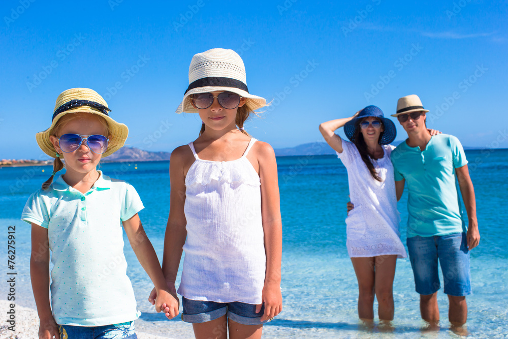 Happy family with two kids during tropical beach vacation