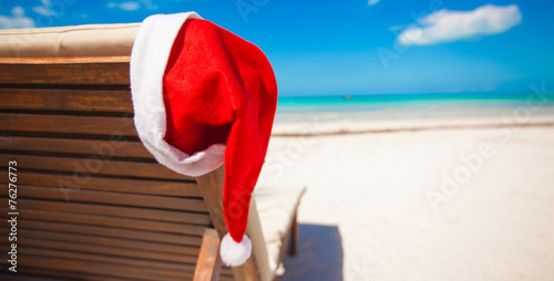 Red santa hat on chair longue at tropical caribbean beach photo