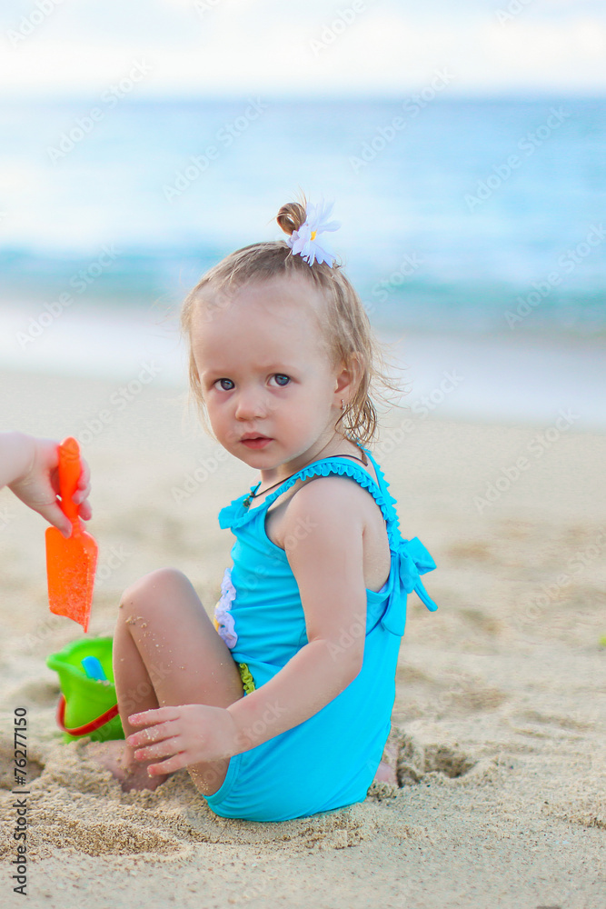 Adorable little girl playing with beach toys during summer Adorable little girl playing with beach toys during summer