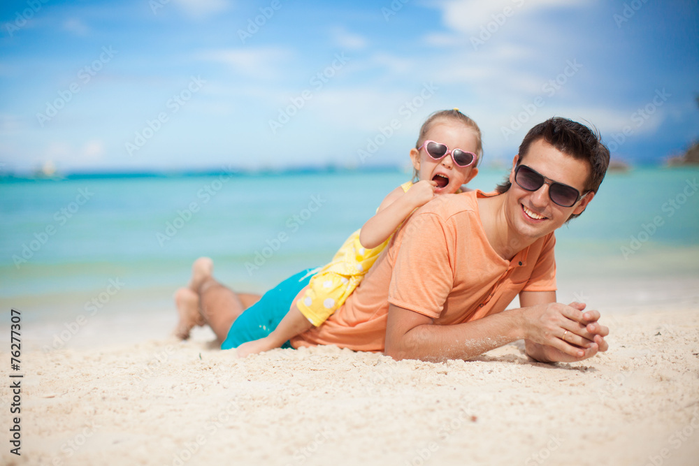 Happy father and his adorable little daughter at tropical beach Happy father and his adorable little daughter at tropical beach