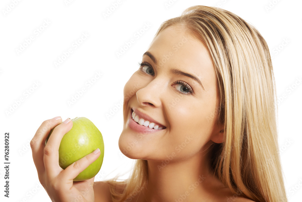 Smiling beautiful woman holding an apple Smiling beautiful woman holding an apple