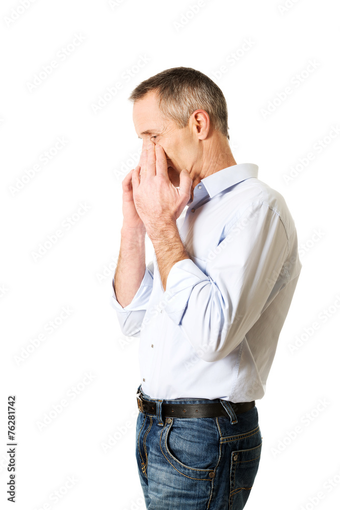 Man holding his nose because of sinus pain Man holding his nose because of sinus pain