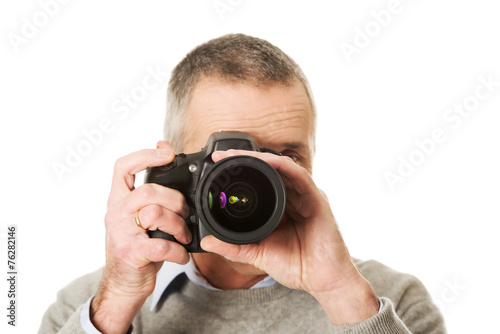 Mature man with photo camera