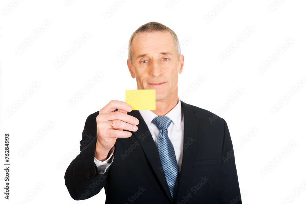 Businessman showing a yellow identity name card Businessman showing a yellow identity name card