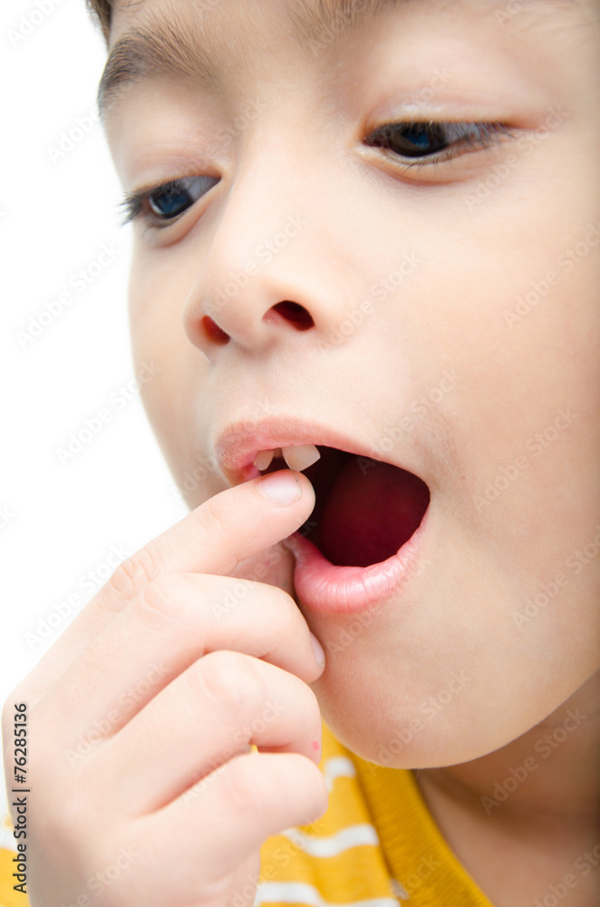 Little boy touching his teeth which going out Little boy touching his teeth which going out