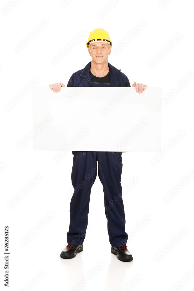 Full length happy worker presenting empty banner Full length happy worker presenting empty banner