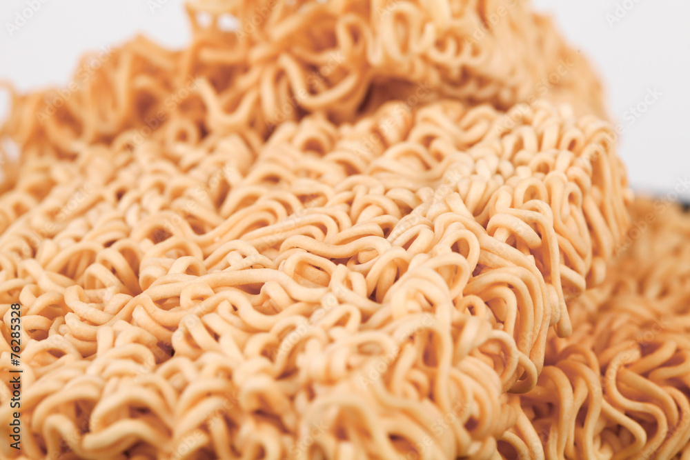 A block of dried Instant noodles on gray background paper A block of dried Instant noodles on gray background paper