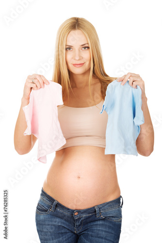 Pregnant woman with two small baby shirts