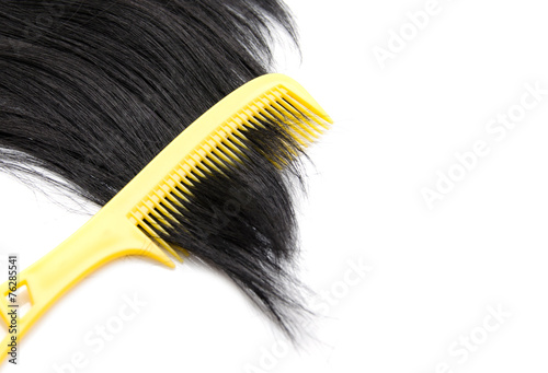 Comb on hair on white background