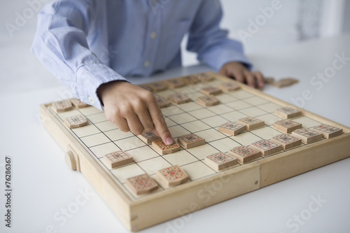 Boy playing with Japanese chess