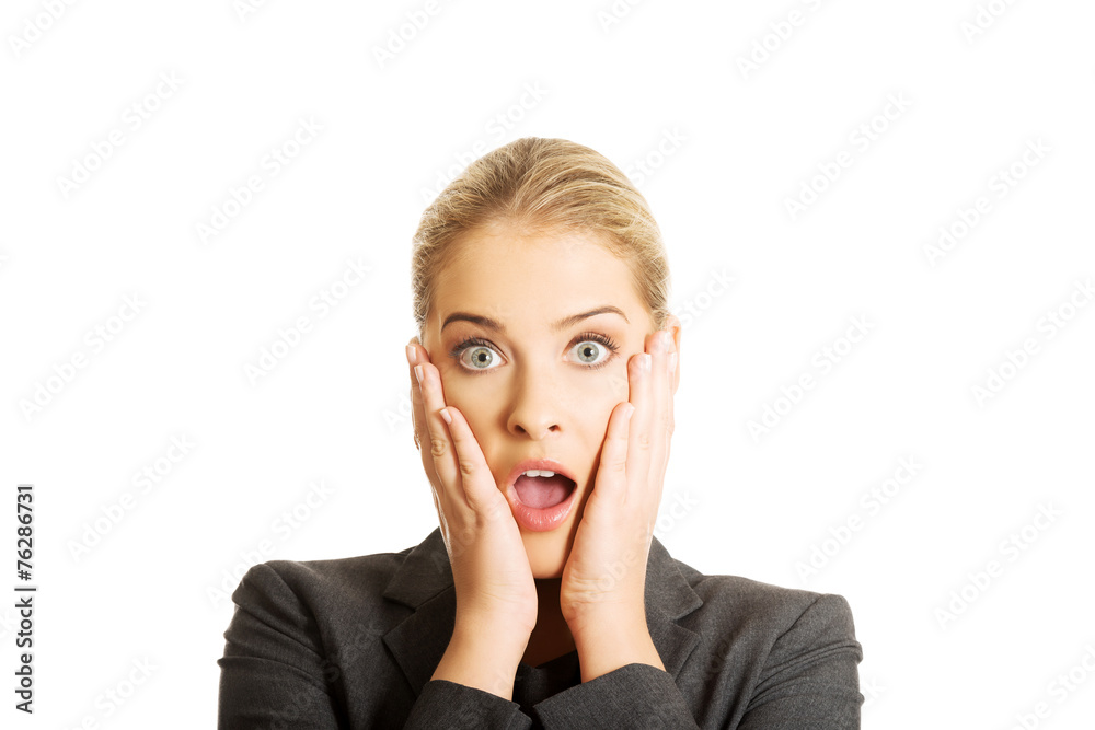 Shocked woman holding hands on chin Shocked woman holding hands on chin