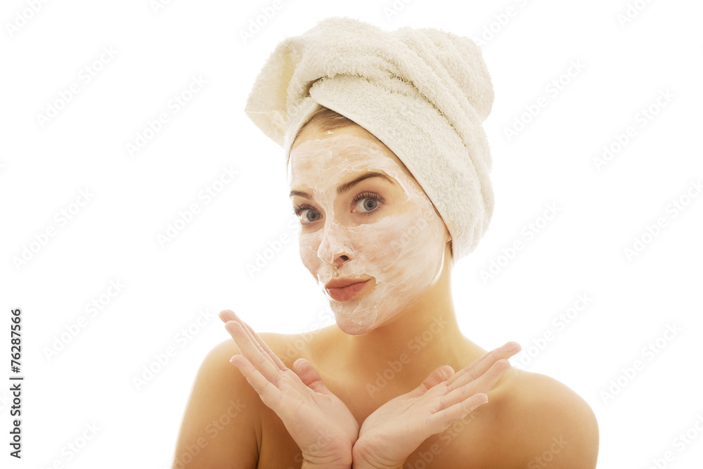 Portrait of a woman with cream lotion on face spreading hands Portrait of a woman with cream lotion on face spreading hands