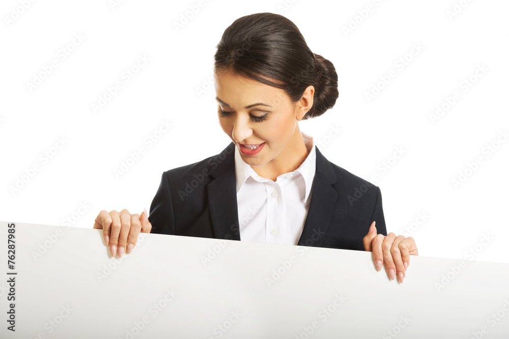 Portrait of businesswoman holding white banner Portrait of businesswoman holding white banner