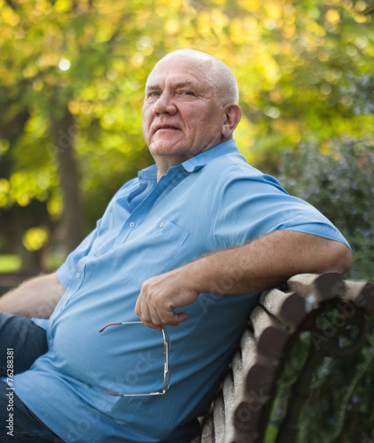 Elderly man sitting on bench