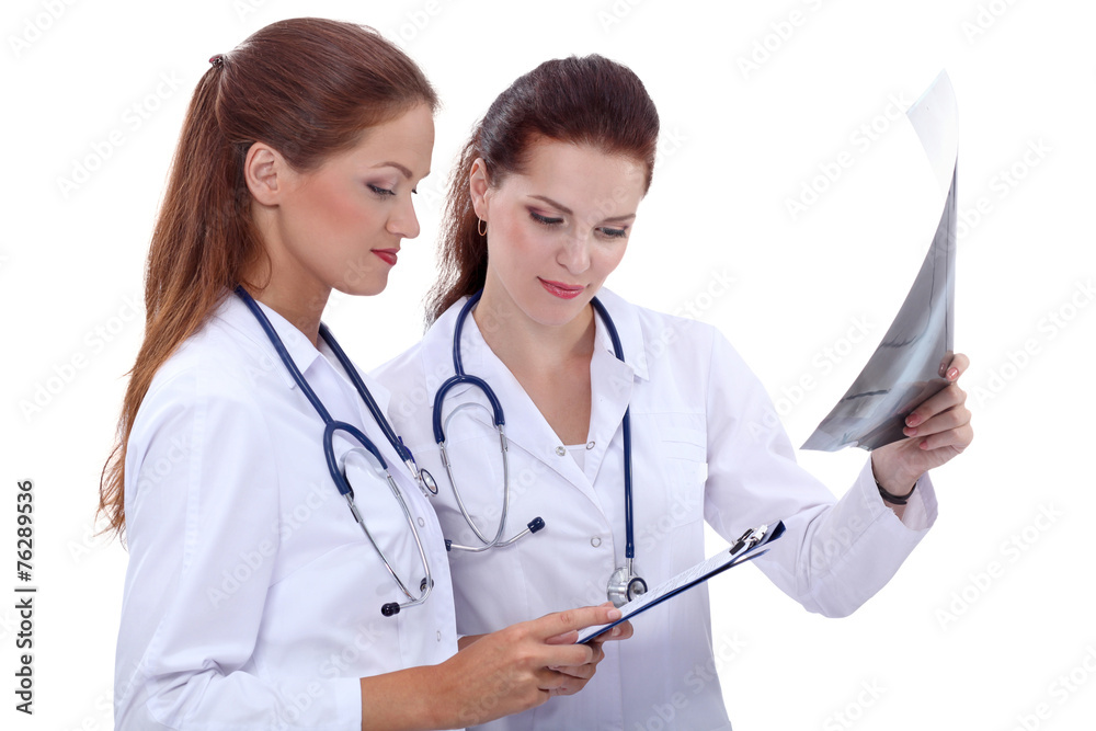 Two woman nurse watching X Ray image, standing in hospital Two woman nurse watching X Ray image, standing in hospital
