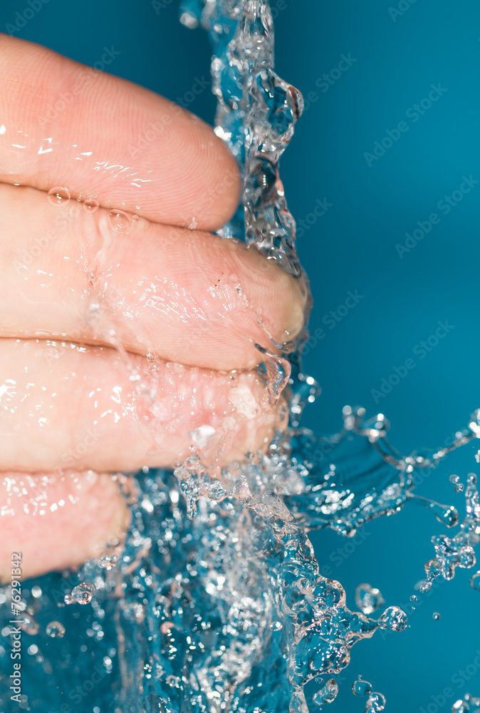 fingers in water on a blue background fingers in water on a blue background