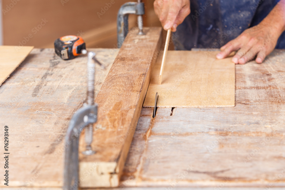 carpenter use saw cut wood for make new furniture