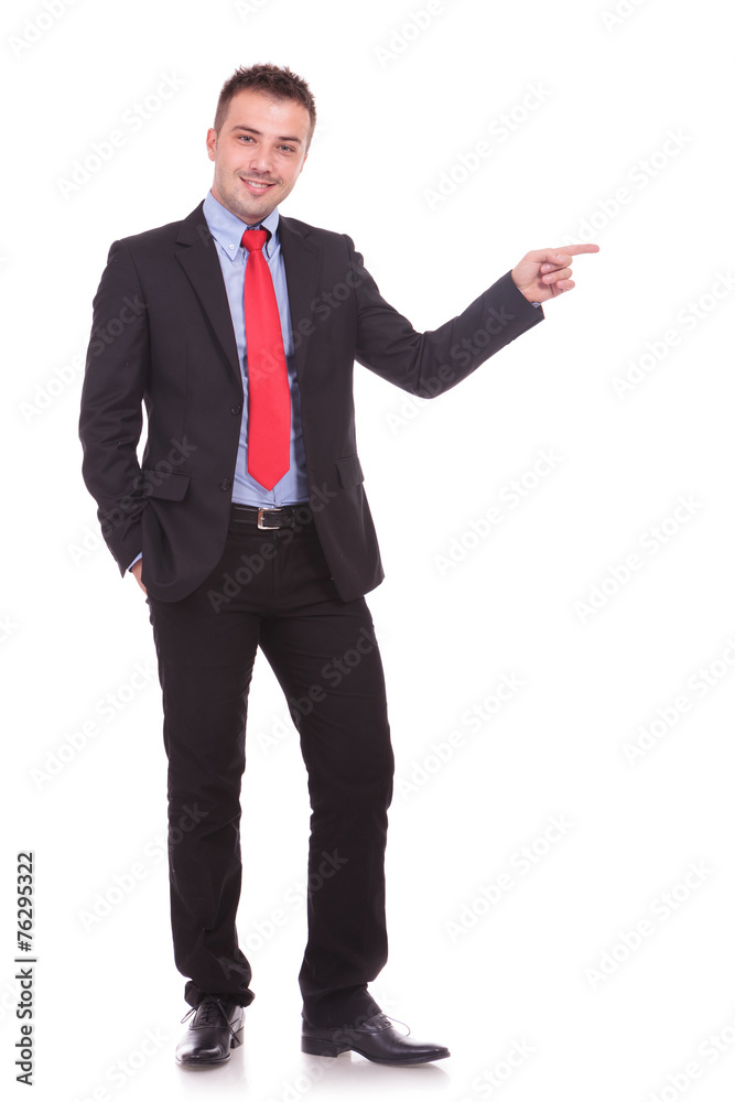Young elegant business man pointing with one hand.