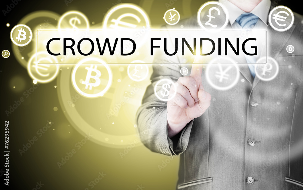 Businessman pushes virtual crowd funding button Businessman pushes virtual crowd funding button
